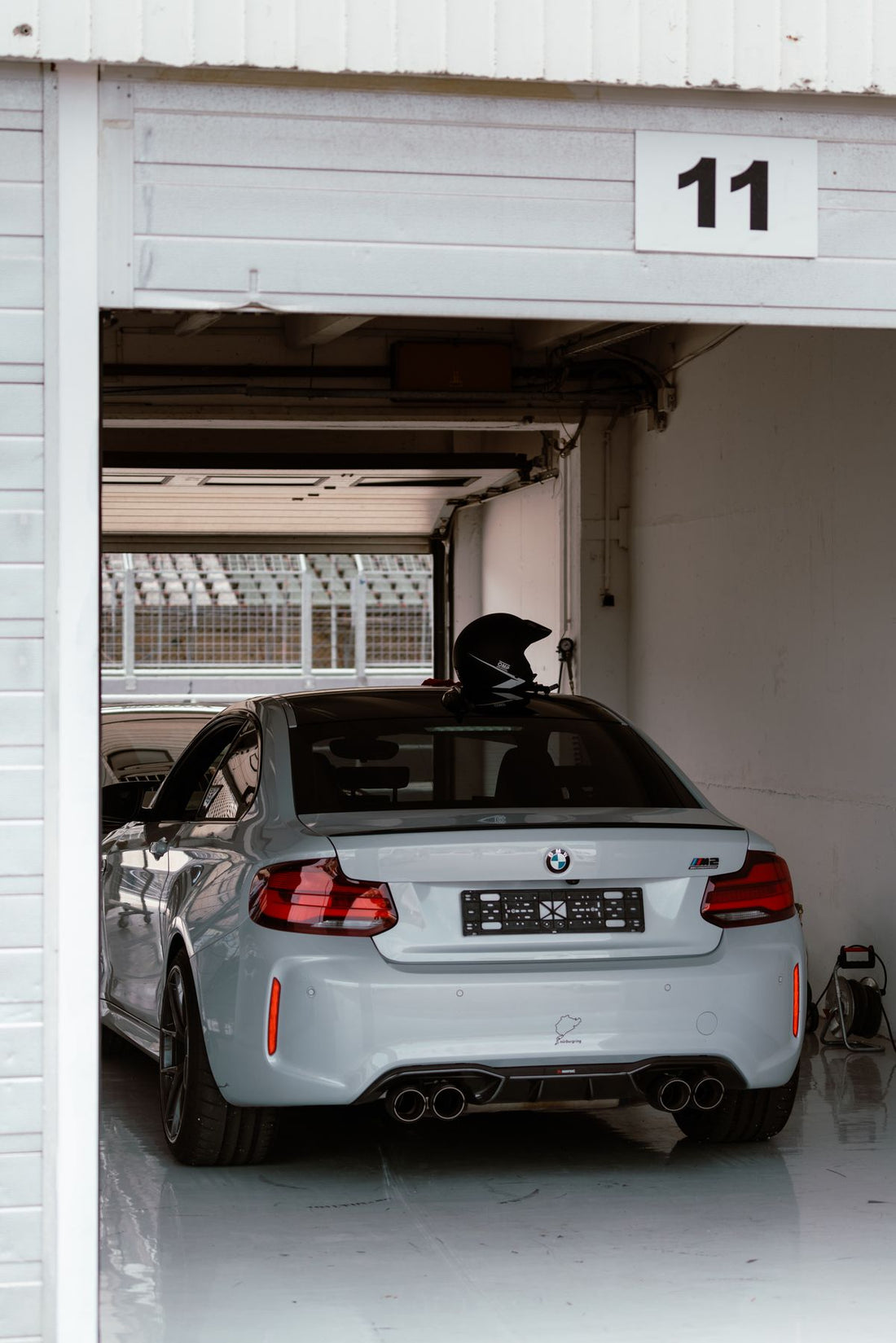 White BMW parked in a modern indoor garage