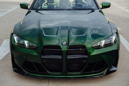 Green BMW G82 M4 front end with kidney grilles and headlights