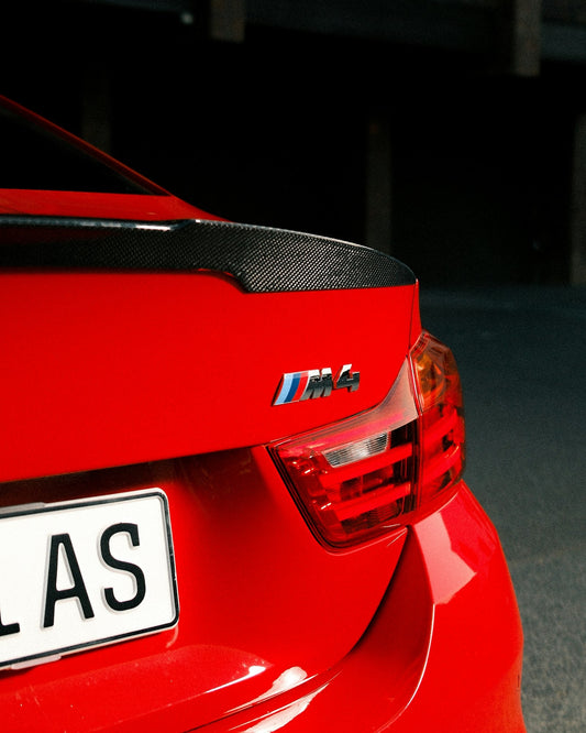 Red BMW M4 photographed from the front three-quarter angle
